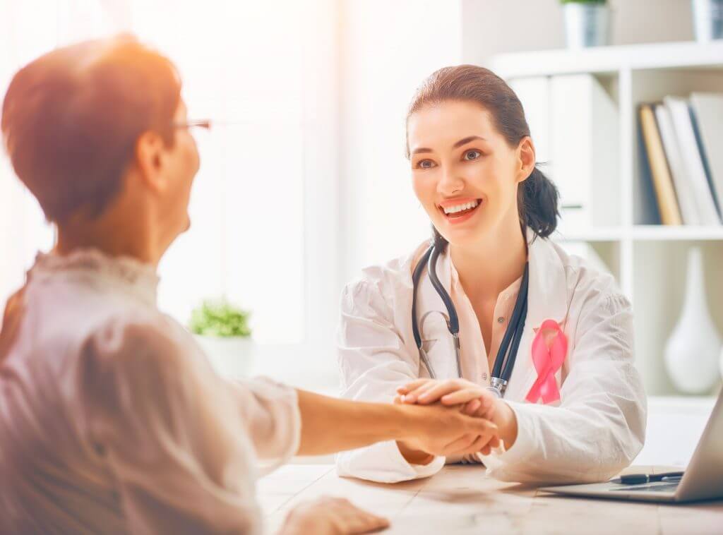 woman and doctor shaking hands